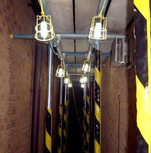 Festoon Lights in a dark hallway with scaffolding