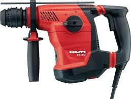 Red and black electric drill with a black grip